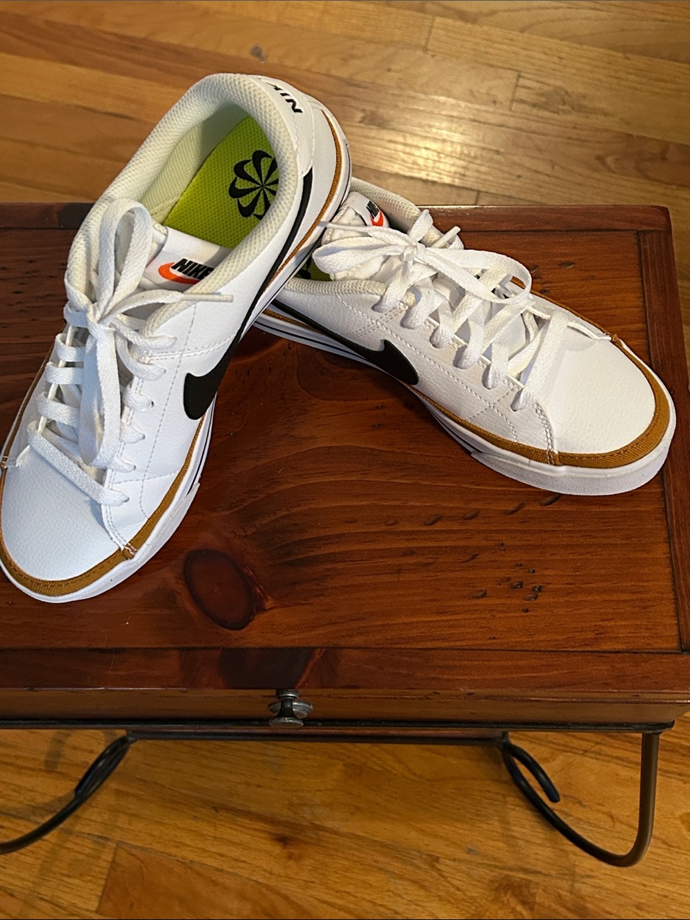 Nike White Low-Top Sneakers with Black Swoosh and Brown Accent
